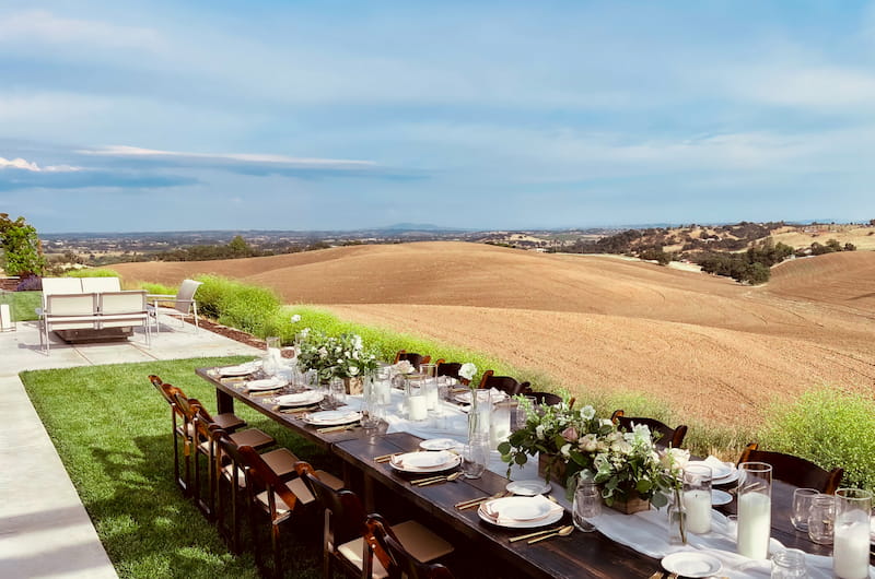 Outdoor table set for a party overlooking fields